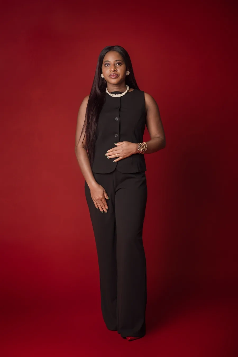 Mimi standing in a tailored black outfit